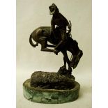 After Frederick Remington (American 1861-1909), a small bronze study, The Outlaw, on naturalistic