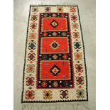 An Azerbaijan wool rug, with rectangular medallions in rectangular field, tan ground with stylised