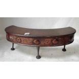 An Arts and Crafts copper fireside Tidy Betty, crescent shape with seven disc decoration to apron on