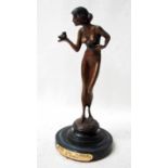 After Moreau, An Art Deco bronze statue of a nude female holding a bird, on circular stepped base