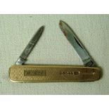 A 9ct gold cased Pen Knife, two steel blades, engine turned decoration, reserved with a