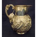 A late Victorian silver Ale Jug of typical globe form with straight neck, cast loop handle with