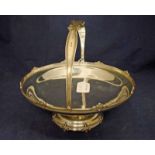 An Art Deco silver swing handle footed Fruit Bowl, circular form with decorative rim, foot and