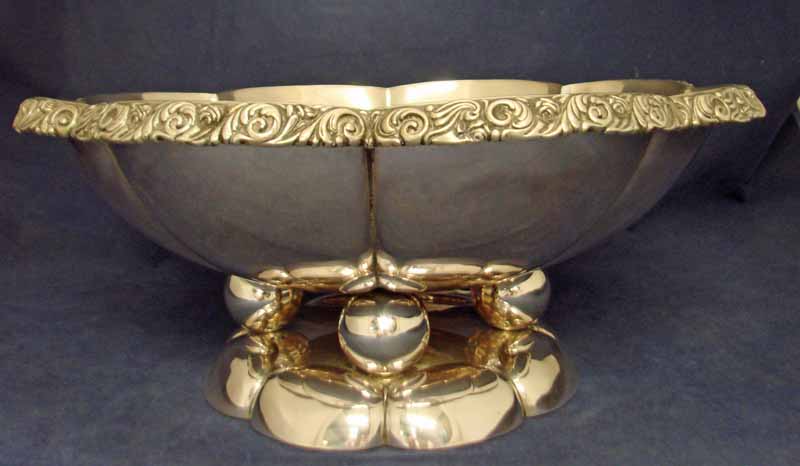A large continental 800 silver Fruit Bowl, flower head circular form with cast foliate rim, on