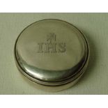 A late 19th century Irish silver Pyx Box, circular form with push on cover, cover inscribed IHS with