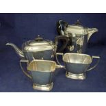 A mid 20th century four-piece silver Tea Service, Art Deco in style, including water jug, ebonised