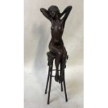 After Chiparus, a bronze figure of a female nude seated on a tall stool, 26cm high