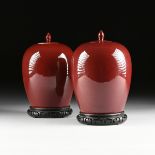 A PAIR OF CHINESE EXPORT OXBLOOD GLAZED PORCELAIN LIDDED JARS, 20TH CENTURY, in the Qing dynasty