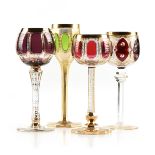 A GROUP OF FOUR LUDWIG MOSER & SOHNE GILT DECORATED FLASHED GLASS WINE STEMS, KARLSBAD (KARLOVY