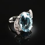 A 14K WHITE GOLD, DIAMOND, AND BLUE TOPAZ LADY'S RING, centering one prong set 18 3/4 x 14 x 10 1/