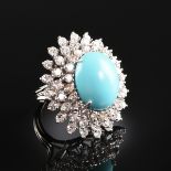 AN 18K WHITE GOLD, DIAMOND, AND TURQUOISE LADY'S RING, centering one oval turquoise cabochon