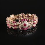 A 14K YELLOW GOLD, RUBY, AND DIAMOND LADY'S BRACELET, set with fifty-five mixed oval cut rubies