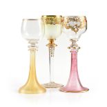 A GROUP OF THREE JOSEPHINENHUTTE ENAMEL AND GILT DECORATED CASED GLASS WINE STEMS, SCHREBERHAU,