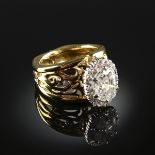 A 14K YELLOW GOLD AND DIAMOND LADY'S RING, centering one oval cut diamond with an approximate