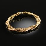 AN 18K YELLOW GOLD LADY'S BRACELET, the two intertwining strands each measuring 3.7 millimeters, the