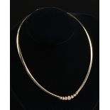 A 14K YELLOW GOLD AND DIAMOND LADY'S OMEGA NECKLACE, with center section set with seven round cut