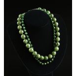 A LADY'S ART DECO FACETED SPINACH JADE AND STERLING SILVER DUAL STRAND NECKLACE, 1900-1940, the