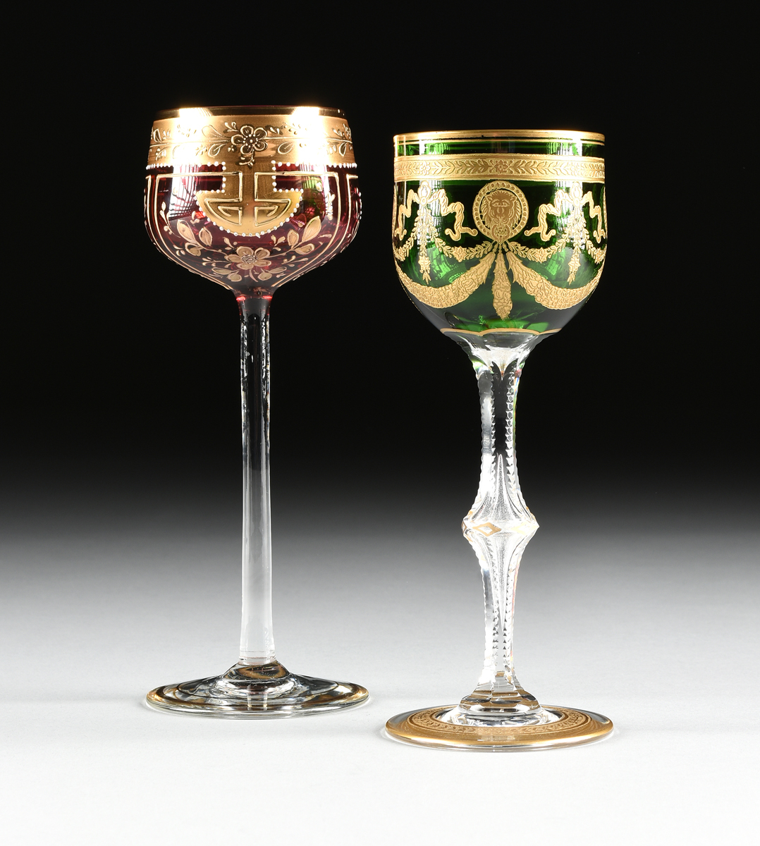 A GROUP OF TWO BOHEMIAN AND FRENCH CASED GILT DECORATED WINE GOBLETS, CIRCA 1900-1910, comprising