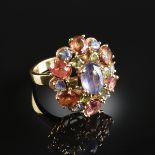 A 14K YELLOW GOLD AND MULTI COLORED SAPPHIRE ANDREW SAROSI LADY'S RING, centering one lavender