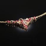 AN 18K YELLOW GOLD, RUBY, AND DIAMOND LADY'S NECKLACE, "V" style design set with twenty-nine