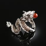 AN 18K WHITE GOLD, DIAMOND, AND PINK SAPPHIRE LADY'S DRAGON RING, designed as a stylized dragon