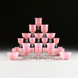 in the manner of STEUBEN GLASS WORKS, A TWENTY-FOUR PIECE SET OF TWISTED PINK OPTIC GLASS WITH CLEAR