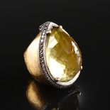 A YELLOW GOLD, CITRINE AND DIAMOND LADY'S RING, the mounting centering a domed pear shape faceted