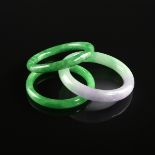 A GROUP OF THREE LADY'S JADE BANGLE BRACELETS, MODERN, comprising one apple green bangle with some