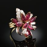 AN 18K TWO TONE GOLD, RUBY, AND DIAMOND LADY'S DINNER RING, set with ten round cut diamonds and