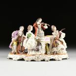 A WARTIME VOLKSTEDT MANUFAKTUR PARCEL GILT ENAMELED FIGURAL PORCELAIN GROUP OF A MUSICAL QUARTET,