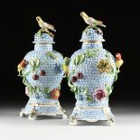A PAIR OF DRESDEN ENCRUSTED FLOWER AND BIRD ENAMELED PORCELAIN LIDDED URNS ON STAND, SAXONY,