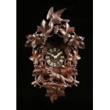 A BLACK FOREST CARVED PINE CUCKOO CLOCK, GERMAN, FIRST HALF 20TH CENTURY, the reticulated bird,