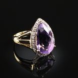 A 14K YELLOW GOLD, AMETHYST, AND DIAMOND LADY'S RING, centering a pear shape amethyst with