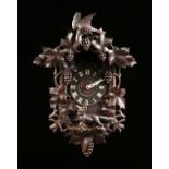 A BLACK FOREST CARVED PINE CUCKOO CLOCK, GERMAN, 1945-1990,