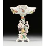 A DRESDEN STYLE PARCEL GILT POLYCHROME PORCELAIN FIGURAL CENTERPIECE, BY ACKERMANN & FRITZE (1908-