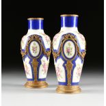 A CASED PAIR OF FRENCH SEVRES STYLE GILT METAL MOUNTED GILT AND POLYCHROME ENAMEL DECORATED