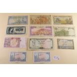 A wad of world banknotes including: Central Bank of Yemen 1981 10 Rials, 1973 50 Rials, 1979 100
