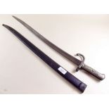 A late 19th century French bayonet with brass handle and metal scabbard