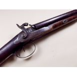 An early 19th century percussion action shotgun with figured walnut stock, ram rod and silver mounts