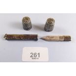 Two silver thimbles and a silver pencil holder