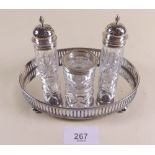 A three piece condiment set with silver mounts, London 1892 - on oval tray