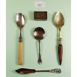 A silver matchbox cover, Birmingham 1912, a silver butter knife, two silver spoons and a horn