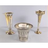 A silver embossed spill vase, Sheffield 1904 45g, another silver weighted vase Birmingham 1919,