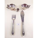 A pair of silver plated fish servers, two squirrel topped nut bowls and a silver salt a/f