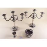 A pair of silver plated candelabra, a silver plated bottle coaster and a silver eggcup