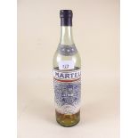 An old bottle of Martell Cognac - sealed but some evaporated