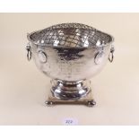 A silver plated hammered effect pedestal rose bowl with lion handles and inset coins - 21cm dia