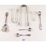 Three pairs of silver sugar tongs, three silver cruet spoons and a silver caddy spoon, total 119g