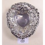 A silver heart form bon-bon dish with pierced decoration standing on three ball feet, 12cm -