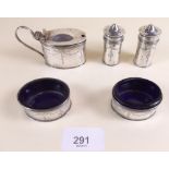 A silver condiment set with engraved swag decoration, comprising a pair of pepper pots (one glass